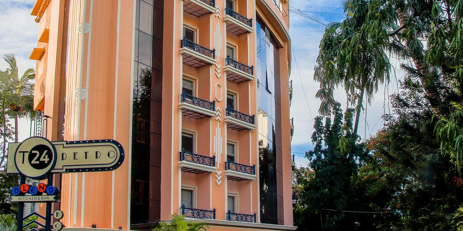 Shot of the facade of the hotel with clear sky in the background  | T24 Retro