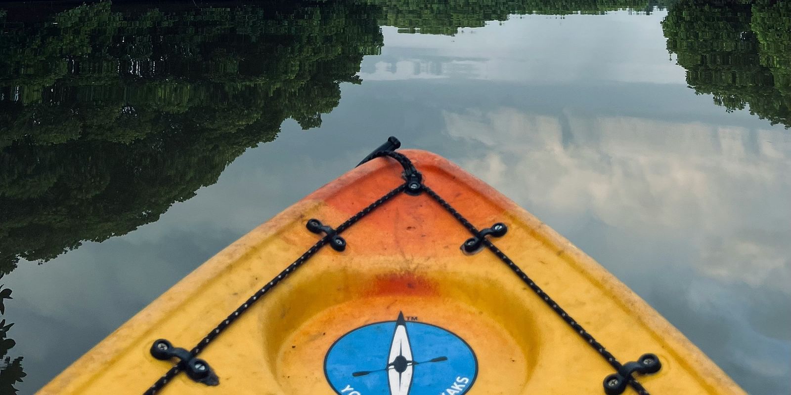 Serene kayak adventure through lush mangrove forests at Matsya Island Retreat, reflecting calm waters and peaceful skies.