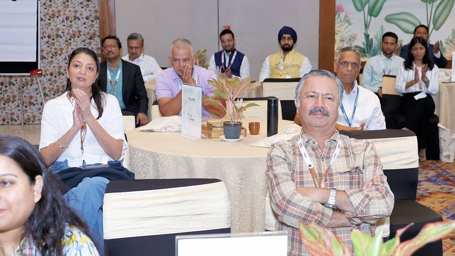 Group of participants seated at a table during a discussion - Karma Lakelands.