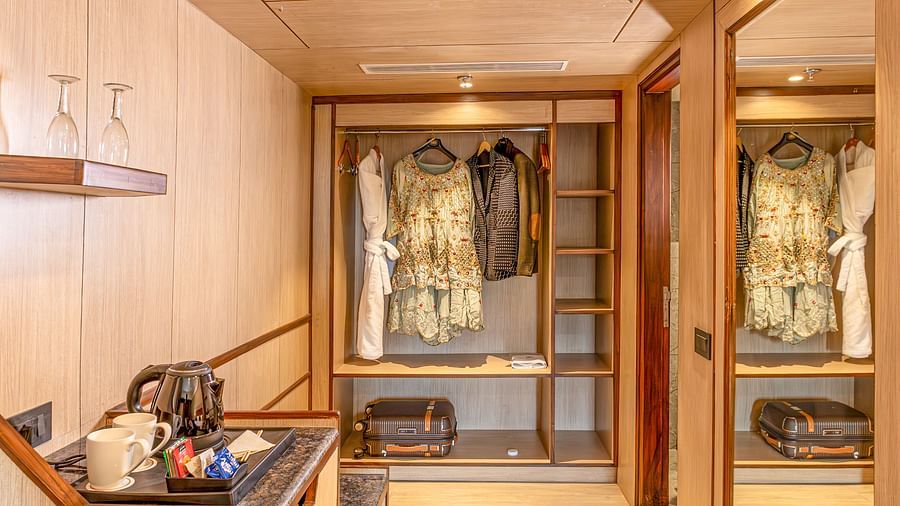 Luxury hotel room detail: tea setup and wardrobe at The Lalita Grand