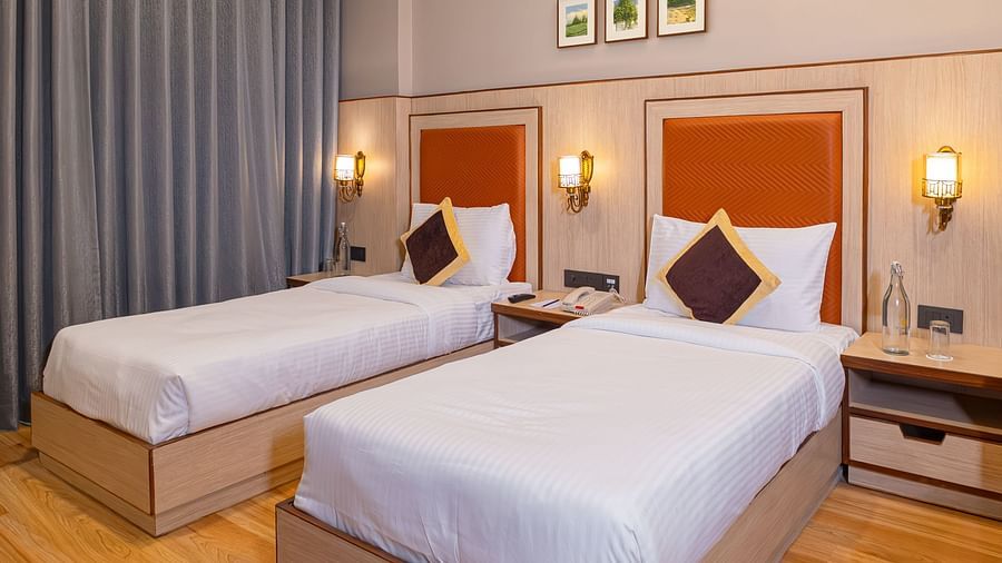 Comfortable twin beds in a modern room at The Lalita Grand hotel