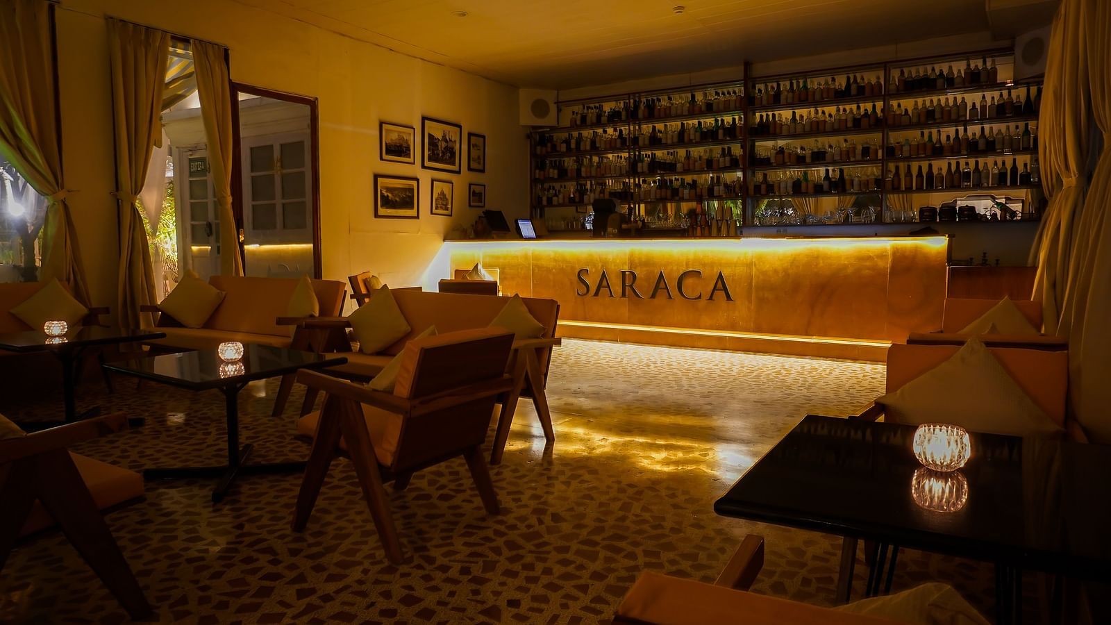 Interiors of Saraca Bar at Saraca Hotel, Lucknow with a wooden theme and a moody ambience with spot lighting