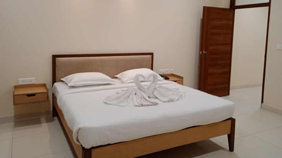 A M Suites, Secunderabad Secunderabad A room featuring a well decorated bed and side drawers.jpg