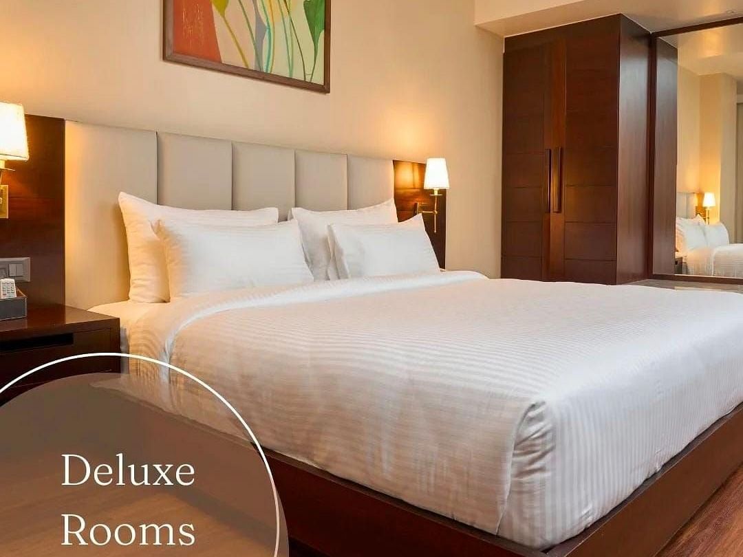 Image of a double bed at Deluxe King room at Visthara - Urban Boutique Hotel, Bangalore