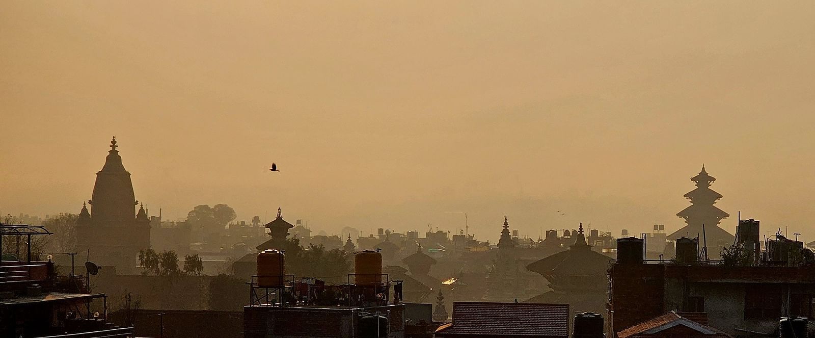 The rooftop offers a city view with the silhouette of buildings against the skyline.