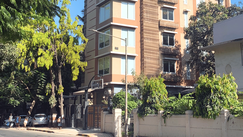facade of theory9 service apartments in bandra during the day with trees in view.