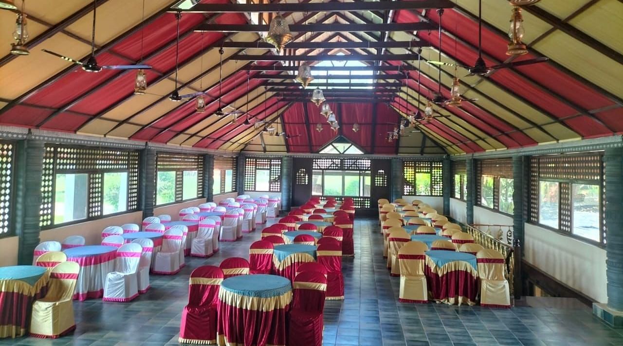 image of the Tambulam banquet hall with a vast seating area for guests - Hoysala Village Resort, Hassan.