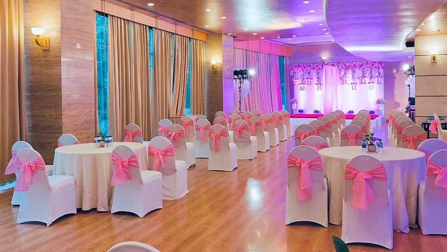 Indoor event space with pink chair sashes at The Orchid Hotel Mumbai Vile Parle