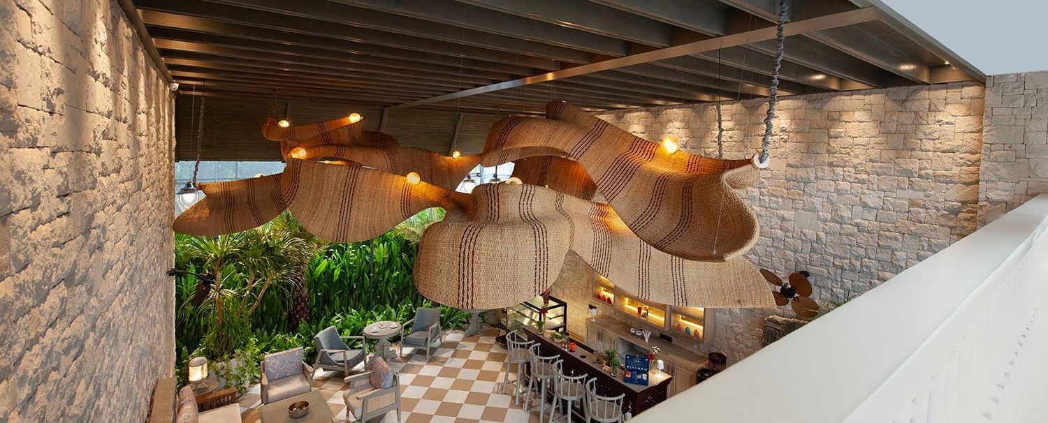 Full view of Suenos de Cafe taken from a higher level featuring an expansive dining area with ample of natural light falling over it.