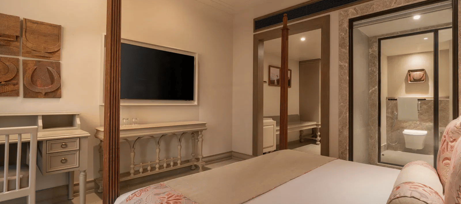 The Classic Room at The Evren, Vagator, featuring a double bed along with a wall-mounted television in front of it.