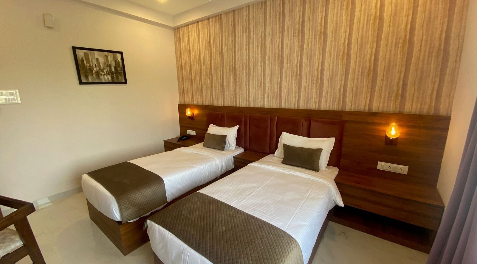 Side view of room with twin beds at Hotel Mumbai House, Indore