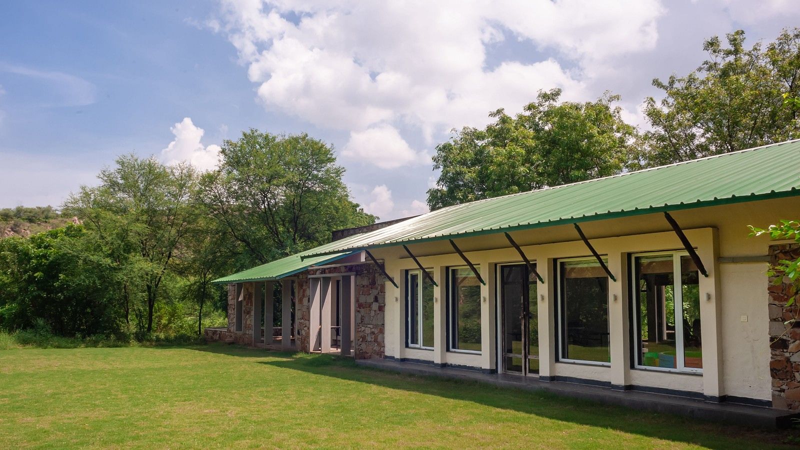 An exterior view of the cottages during the day at Trees N Tigers