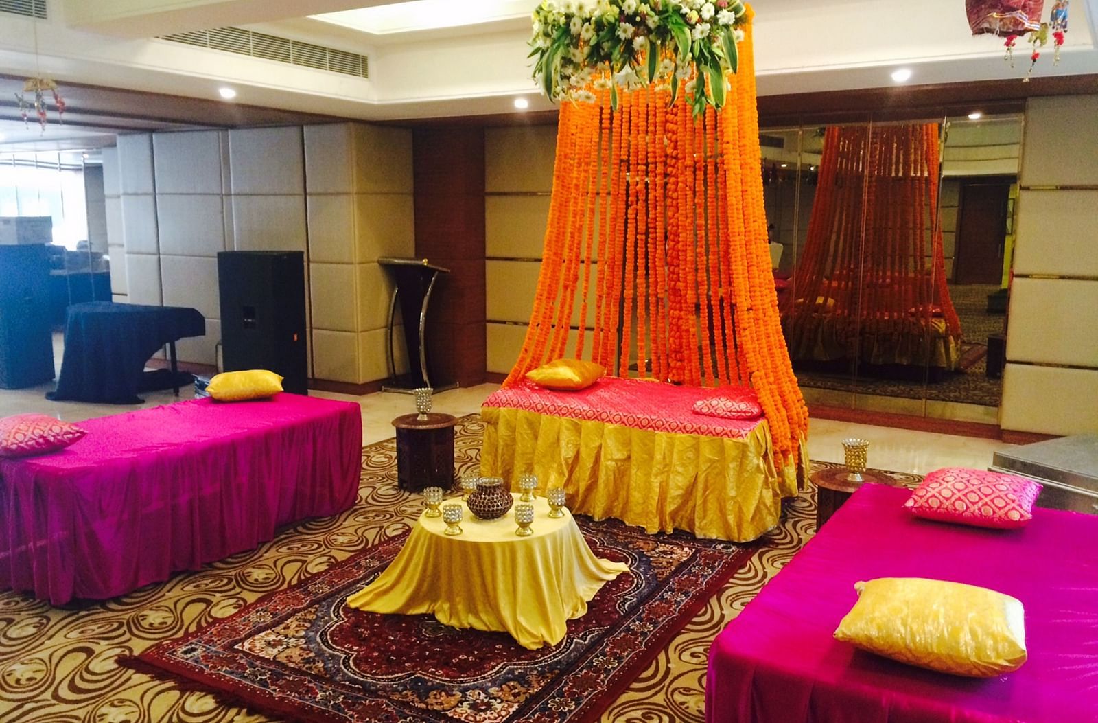 A beautiful seating area set up in the Emerald hall with a centre table kept over a patterned carpet - Ramada by Wyndham, Ghaziabad, Vasundhara