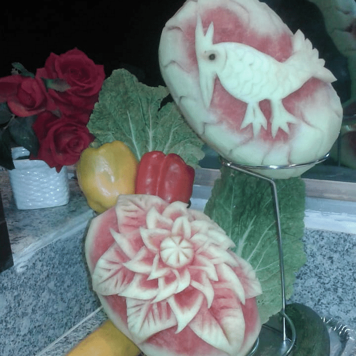 Intricately carved fruit display featuring floral patterns on melons at Central Courtyard Boutique Hotel.
