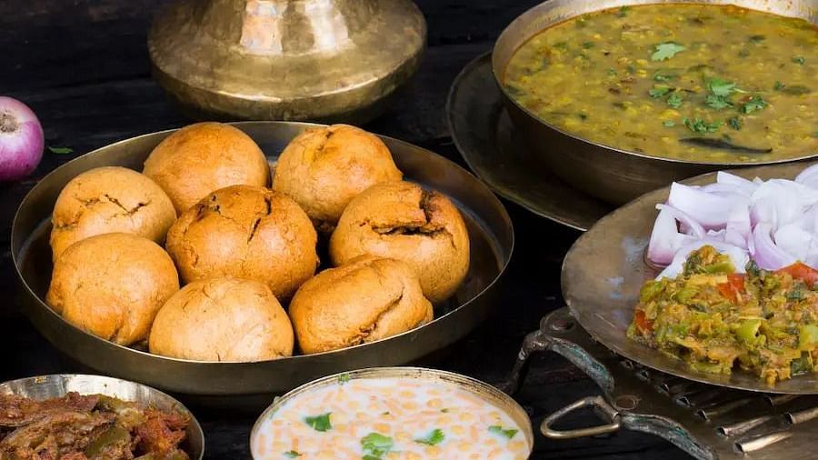 Dal Bati served alongside raita and ghee