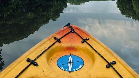 Serene kayak adventure through lush mangrove forests at Matsya Island Retreat, reflecting calm waters and peaceful skies.
