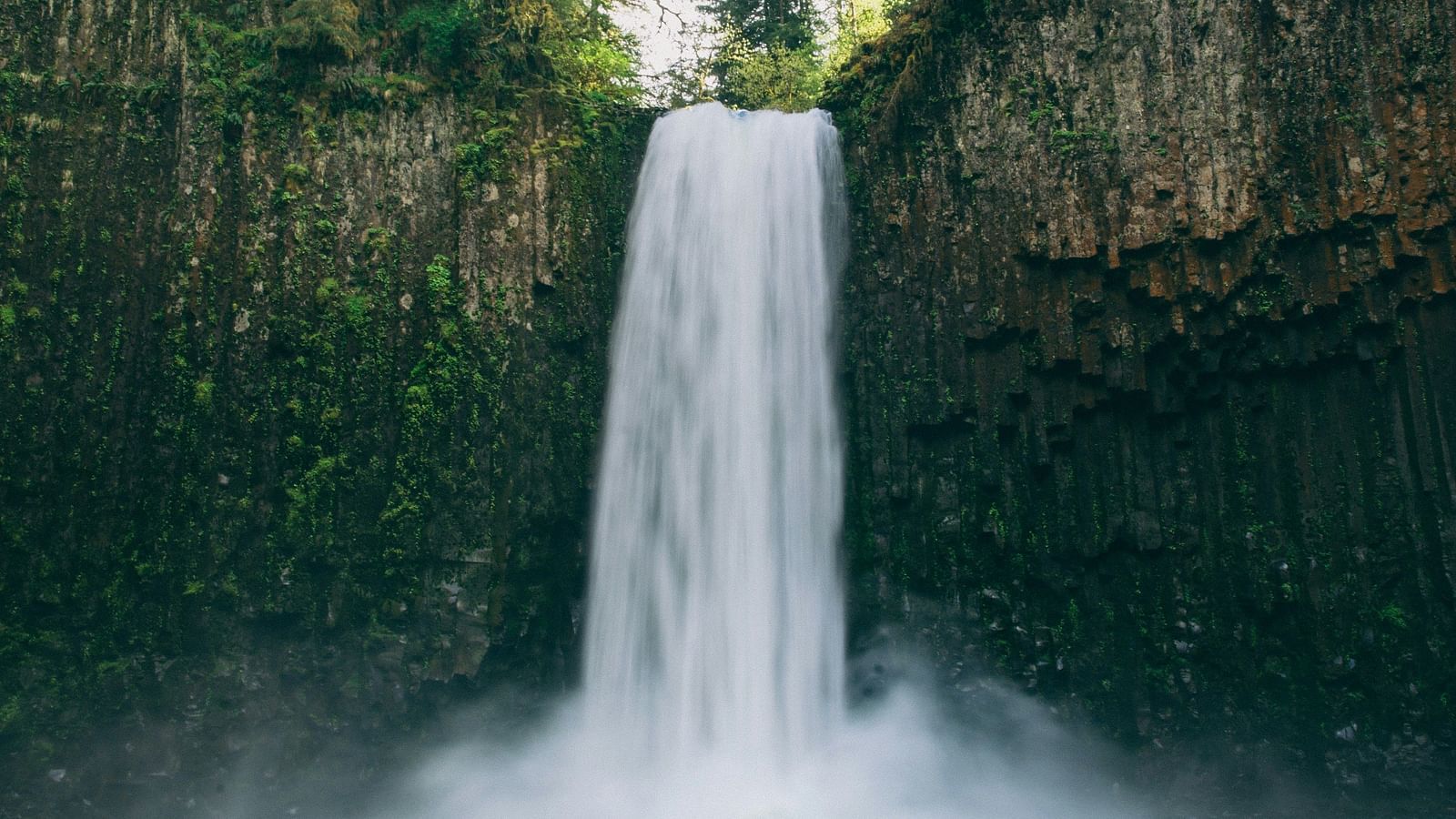 Image of a watefall flowing through a cliff