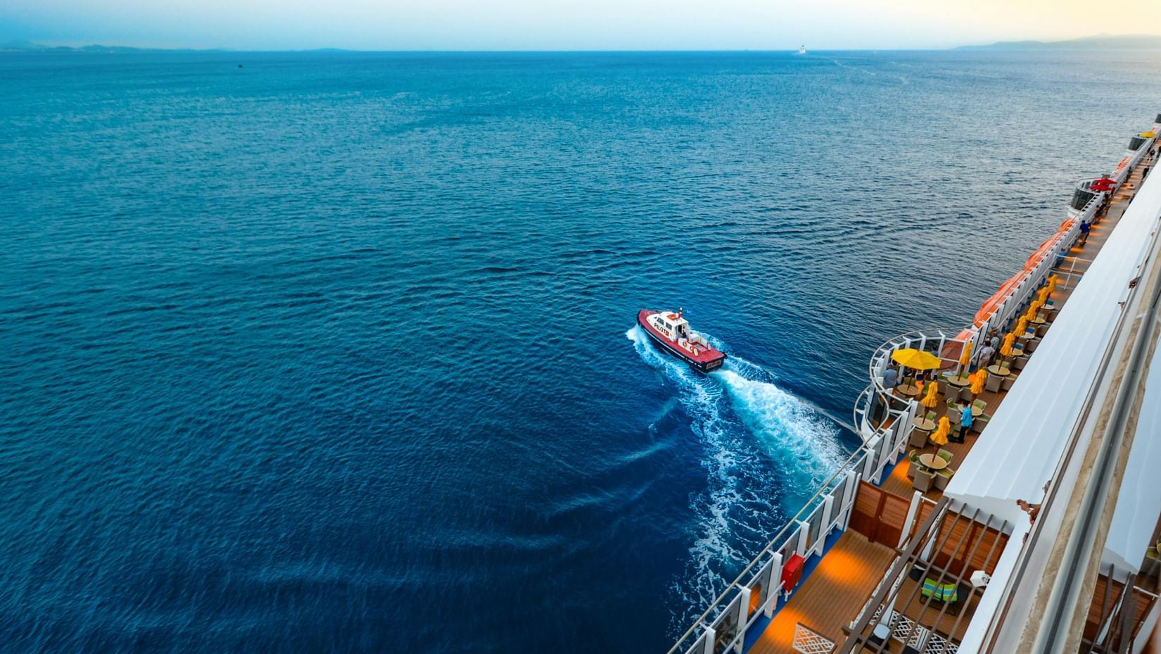 High-angle view through a cruise of people sailing on sea on a boat.