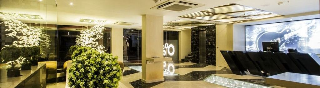 Reception area with table and plants on the side at Art Boutique Hotel, Hyderabad 