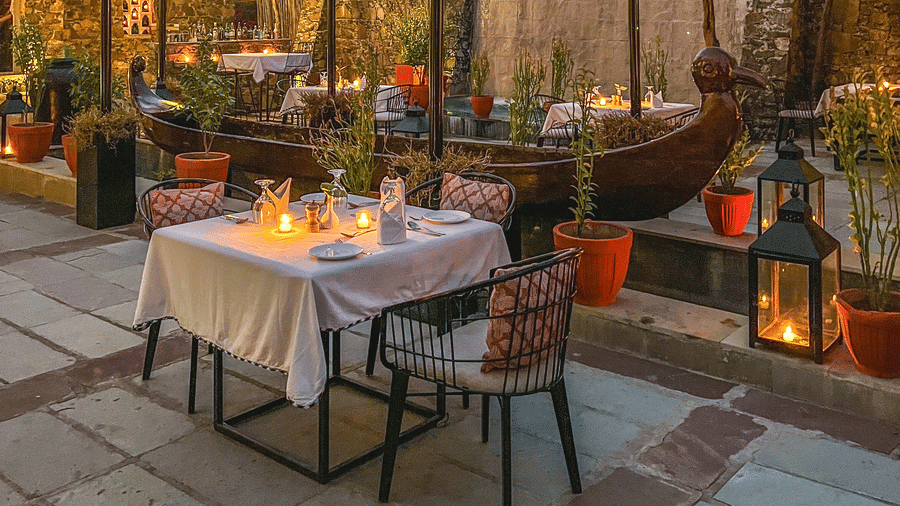 An image of an outdoor seating at the hotel with decorative lighting - Utsav Camp Sariska