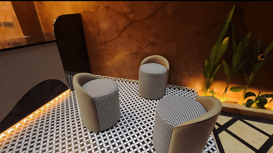 3 small cushioned chairs kept in front of the cafe counter at F Hotels, Bengaluru.