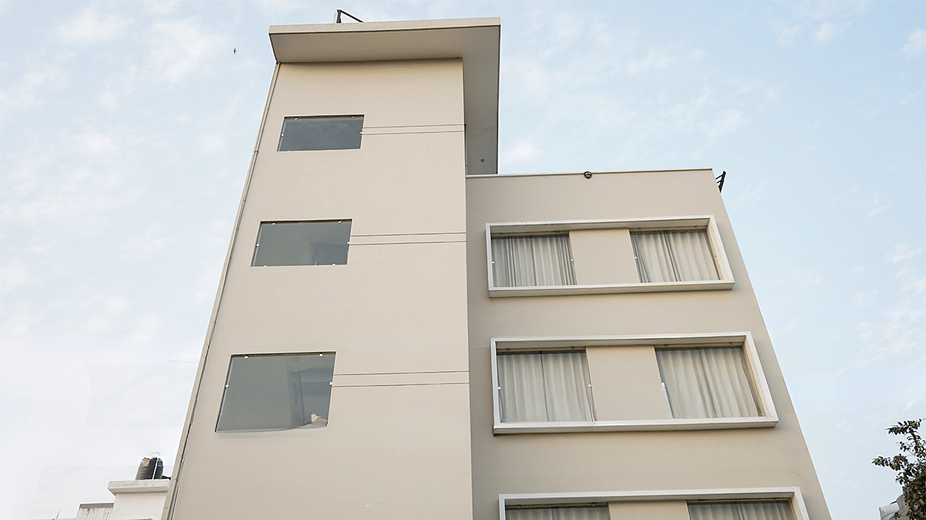 Facade of Five Elements Hotels, Haridwar, set against a clear sky