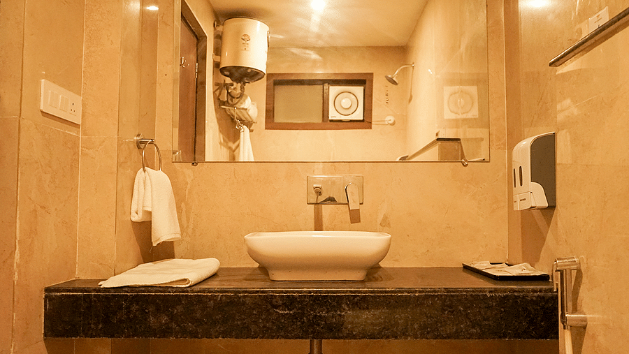 Washroom at Five Elements Hotels, Haridwar, with a wall-mounted mirror and a sink