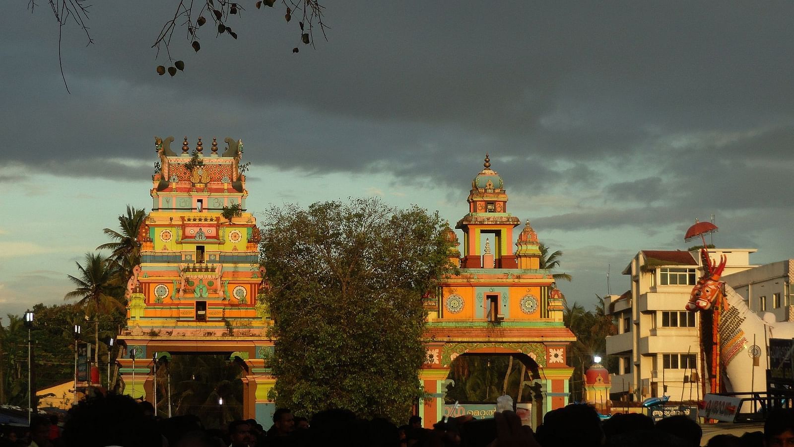 Temple with trees surrounding the background and rainy clouds in the sky