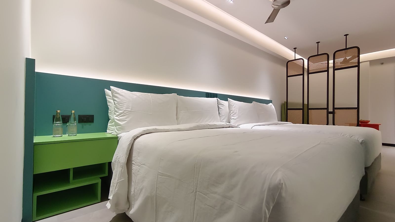 Vibrant bedroom with colourful interiors and a neatly made large bed