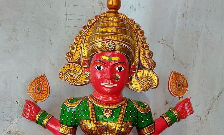 Kinnal craft wooden idol of a deity with a golden crown
