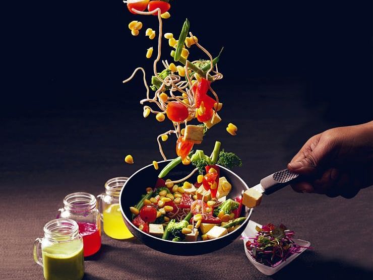 Salad served with an artistic vertical presentation and colourful garnishes.