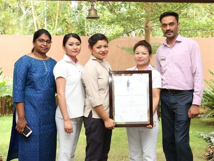 Staff showing their winning certificate.