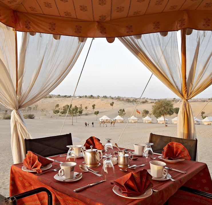 A close up shot of the outdoor dining arrangement over the arid desert region - MANVAR Resort & Desert Camp