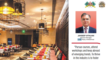 A magazine spread featuring a hotel restaurant and a profile of a general manager.