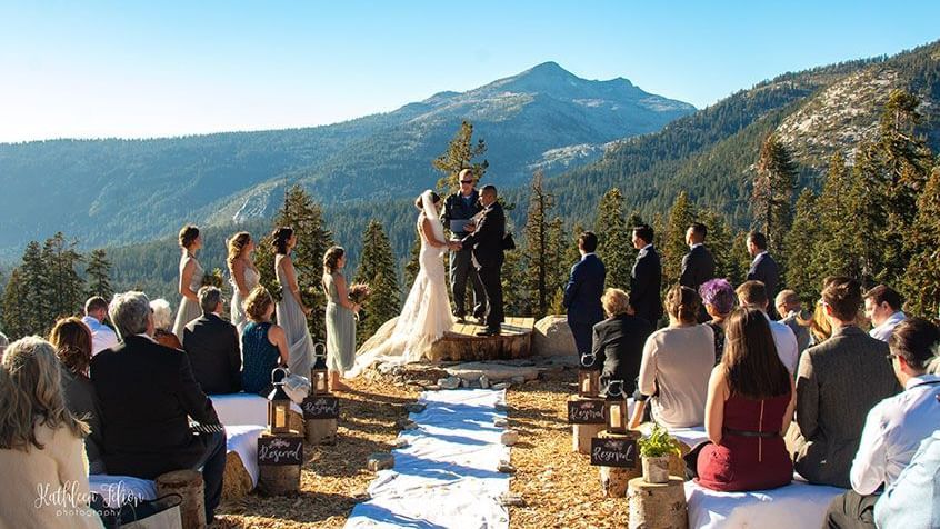 An outdoor wedding ceremony with a mountain backdrop, a memorable event near the Tallman Hotel.