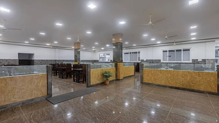 Brightly lit buffet area with organised counters and seating at Siri Ambari Resorts and Spa.