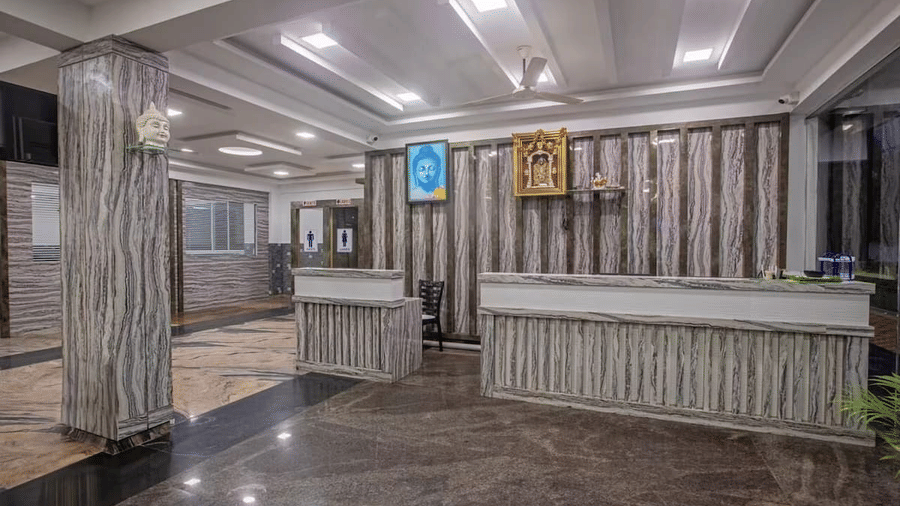 Elegant hotel reception area with wooden decor and modern lighting at Siri Ambari Resorts and Spa.