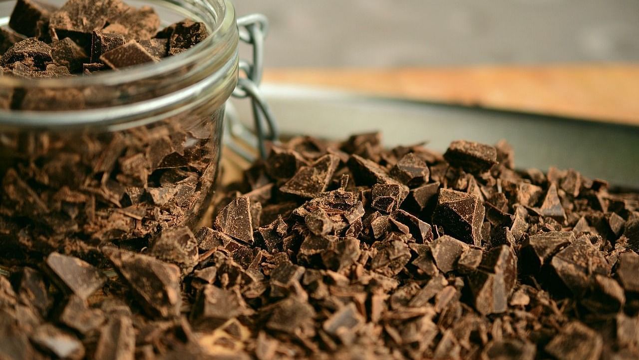 Close-up of chocolate shavings with a glass jar in the background.