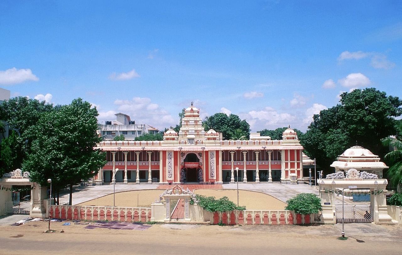 A multi-story temple building with intricate detailing, featuring a prominent central dome and smaller decorative elements.