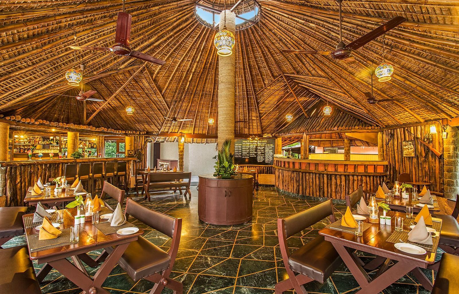An image of a grill house with wooden interiors, wooden chairs and tables