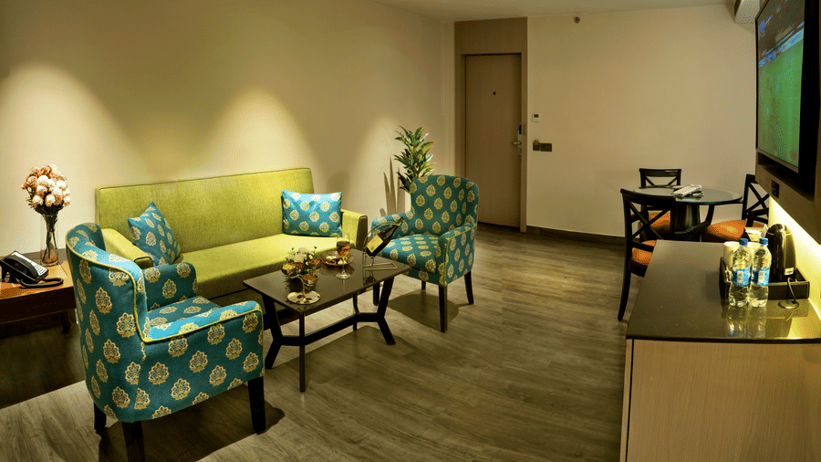 Comfortable living area with lounge seating and work desk at The Sonnet, Jamshedpur.