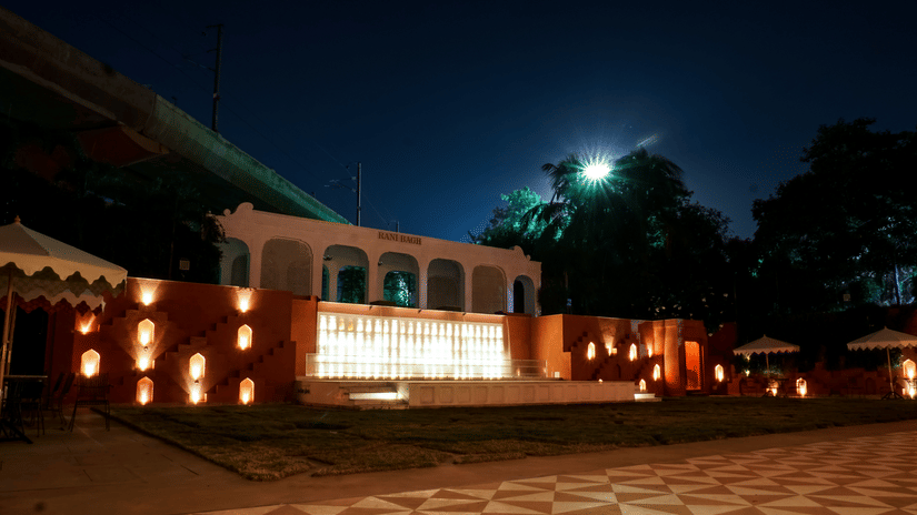 Night view of Clarks Avadh hotel with glowing entrance lights.