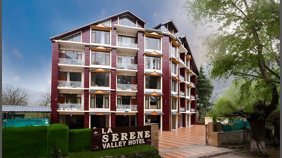 Image of the facade of the hotel with clear sky in the background | DLS La Serene Manali