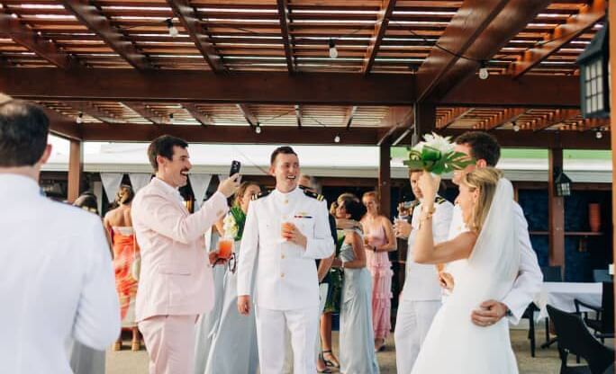 Bride and groom walk down the aisle under a wood pavilion, surrounded by guests at Abaco Inn.