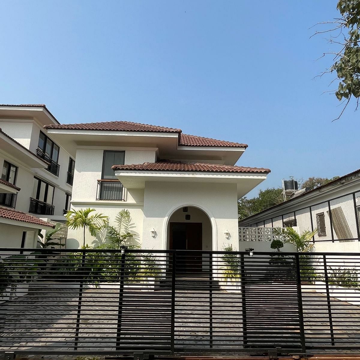A grand residential villa with a black gate, arched entrance, and a modern architectural design - BluSalzz Villas - Alocassia, Anjuna.