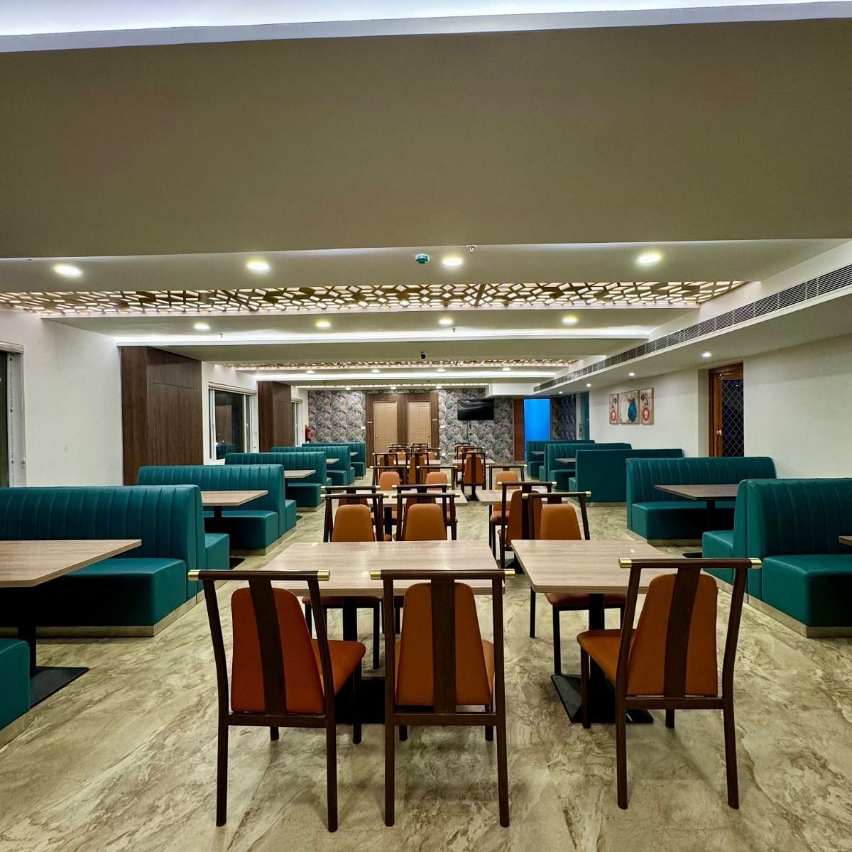 Image of a dining space with chairs and sofas at Le Royale Palace.