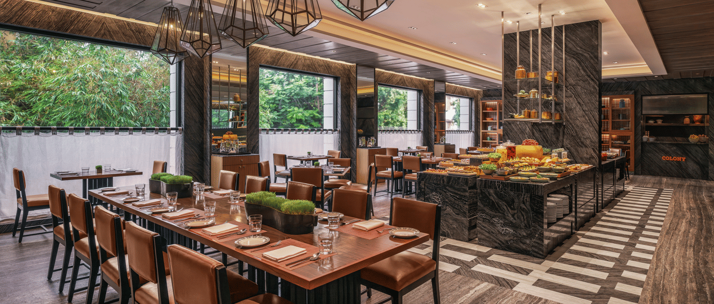 Dining area with large windows and neatly arranged tables at The Raintree, St. Mary’s Road.