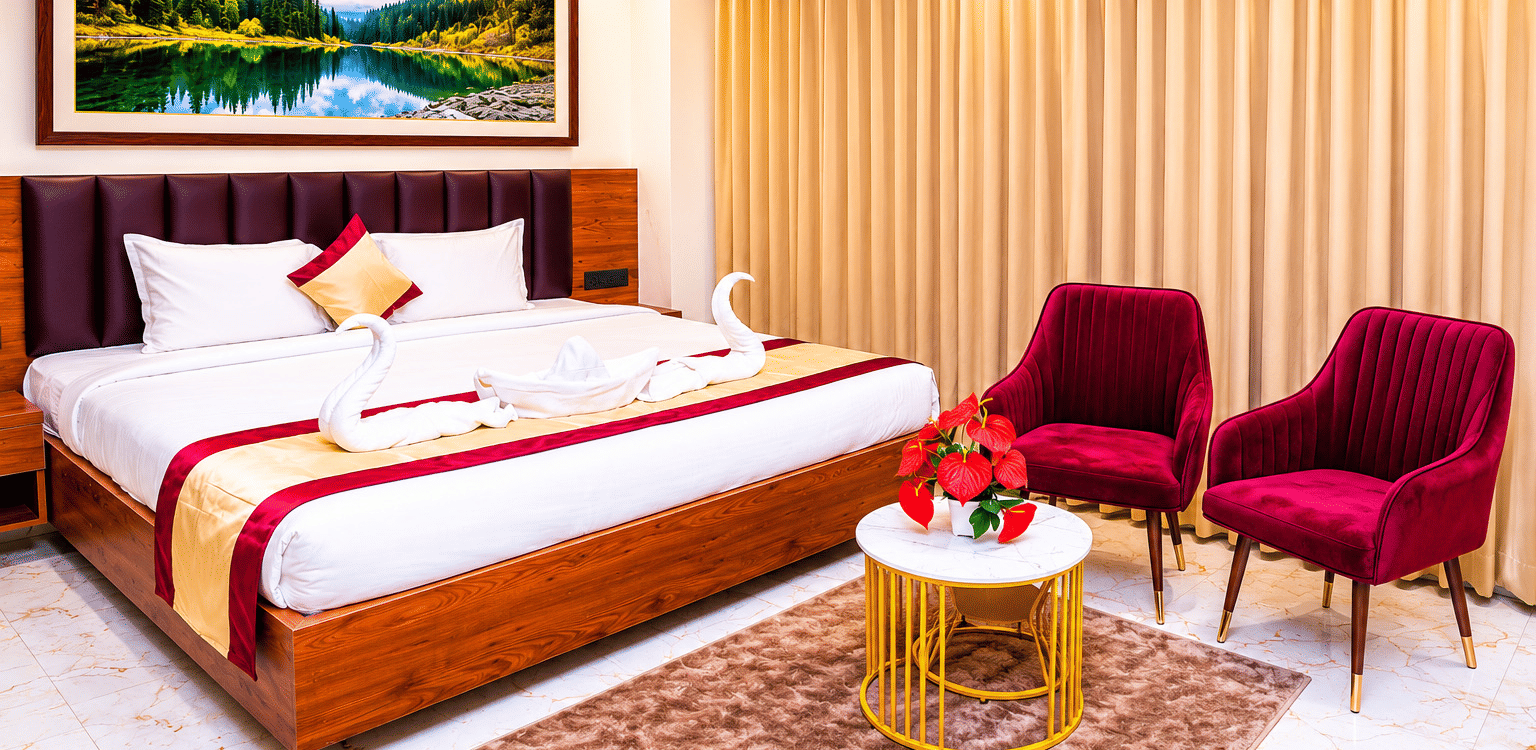 A spacious Executive Room at Hotel Galadari featuring a bed with towel swans, a seating area with 2 chairs, and a nature painting on the wall.