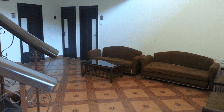 The lobby of the bungalow at the resort furnished with twin sofas and a centre table.