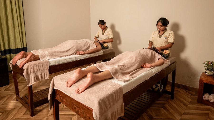Two people receiving massages in a twin spa room at Silver Sand Beach Resort, Havelock.